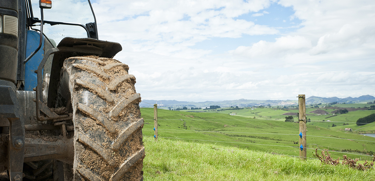 photo of backside tractor with overview of the green hill side
