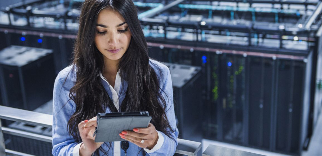 Woman in datacenter holding a tablet